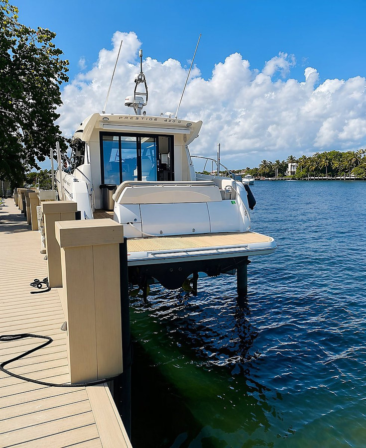 Luxury yacht secured on a boat lift at a South Florida dock