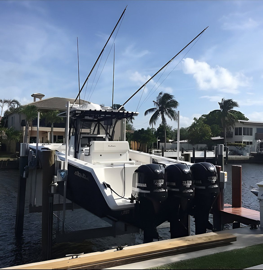 Center console on boat lift, side view — South Florida waterfront by Contour Marine