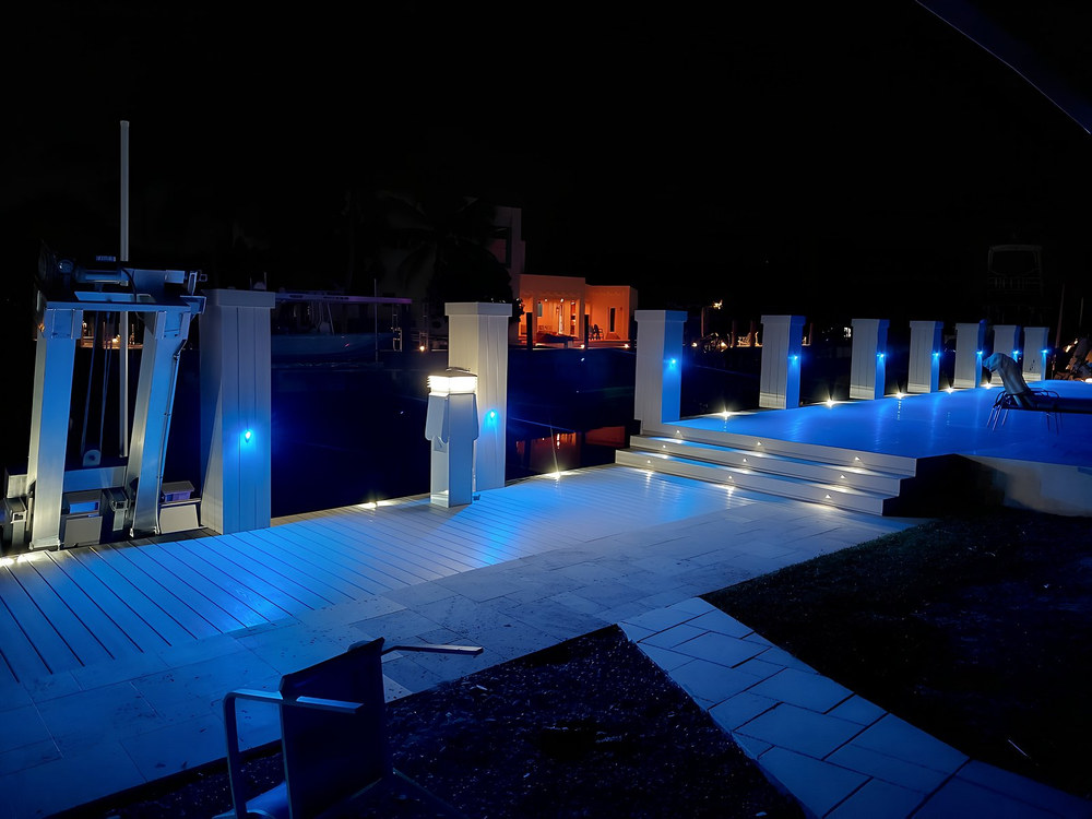 Composite dock with blue LED piling cap lighting and illuminated seawall steps — South Florida