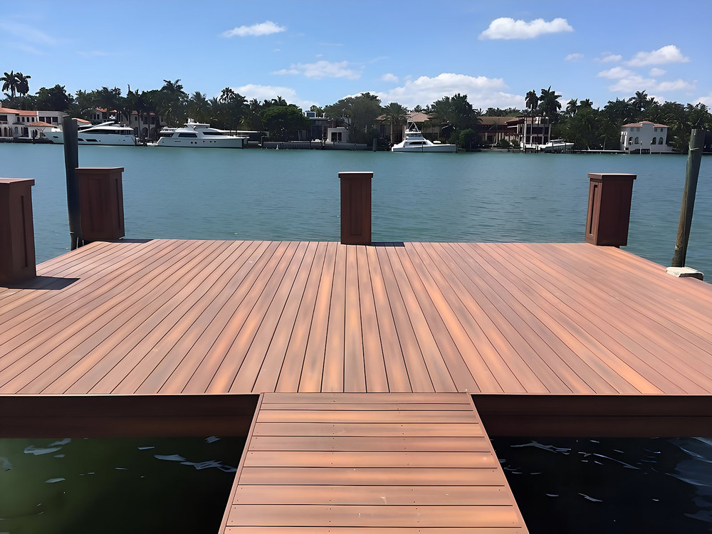 Ipe hardwood dock platform with decorative piling caps overlooking luxury yachts on South Florida waterway